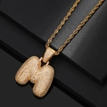Macro view of gold-plated bubble letter M pendant with iced out pave setting zircon - Letter M / Gold
