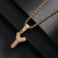 Macro shot of gold-plated letter Y pendant with shimmering pavé zircon on a rope chain - Letter Y Style