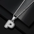 Macro shot of iced out silver letter P pendant with sparkling zircons and twist chain - Letter P / Silver