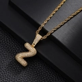 Close-up of golden zircon-encrusted letter Z pendant on a hip-hop rope chain necklace - Letter Z Style