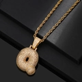 Macro view of iced out gold bubble letter Q pendant with rope chain on black surface - Letter Q / Gold