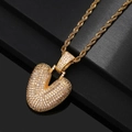 Close-up of golden bubble heart pendant necklace with cubic zirconia on a black stand - Letter V / Gold