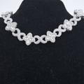 Detail of silver clover and infinity link necklace with clear zircon on black stand - Silver White Rhinestone