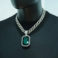 Close-up of iced-out Cuban chain with square emerald-cut green stone on a male bust - Pave Cuban Link / Silver Green Artificial Gemstone With Necklace