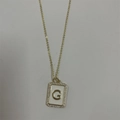 Gold pendant necklace with white letter G rectangular charm and sparkling zircon stones - Letter G
