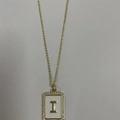 Golden necklace with a white enamel rectangular pendant featuring the letter I and zircons - Letter I