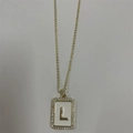 Gold pendant necklace featuring a white enamel letter L with sparkling zircon stones - Letter L
