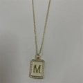 Gold letter M pendant necklace with cream enamel background and zircon stones - Letter M