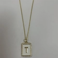 Gold letter T pendant necklace with white enamel inlay and shimmering zircon stones - Letter T