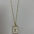 Gold letter X necklace with white enamel inlay and sparkling zircon border detail - Letter X
