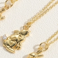 Macro shot of gold rabbit pendant with heart cut-outs and zircon stone on fine chain - Zirconia Rabbit Style (XL2627-MA2-1)