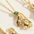 Macro shot of gold rabbit pendant with green stone and pearl on elegant necklace - Mouse Style (XL2627-MA2-1)