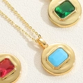 Three gold necklaces with square emerald, ruby, and blue zircon pendants on stone base - Turquoise Blue Zirconia