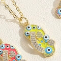 Macro shot of colorful Evil Eye slipper pendants with zircons on gold chains - Yellow (XL2649-4)