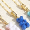 Macro shot of colorful gummy bear pendants with gold cubic zirconia rings on leather background - Blue (XL2599-2)