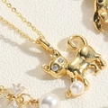 Gold cat pendant necklace with zircon eyes and white pearl drop on textured background - Cat Style (XL2627-MA2-1)