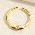 Detailed top view of golden belt buckle ring with vibrant red zircon gemstones - Red Triangular Style