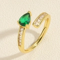 Close-up of gold open ring with emerald green pear-cut stone and rectangle side crystals - Emerald Green Water Drop Style