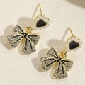 Macro shot of S925 silver needle on heart pearl earrings with bowknot crystal detail - Bowknot Earrings (ES2337-2)