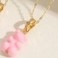 Pink resin bear pendant necklace with gold plated chain and sparkling cubic zirconia stones - Pink (XL2599-6)