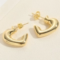 Macro detail of polished gold C-shaped heart stud earrings with butterfly backing - Shiny Gold Heart C-ring Style