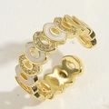 Macro detail of gold-plated open ring featuring white enamel links and cubic zirconia - Adjustable Open / White