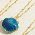Detail view of the deep blue enamel scallop shell pendant on a fine golden chain necklace - Blue