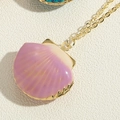 Macro shot of purple gradient scallop shell locket pendant on a gold cross chain - Scallop Pendant (XL3385-6) / Purple