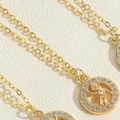 Macro detail of gold astronaut pendant necklace with sparkling cubic zirconia pavé - Astronaut Necklace (XL3128-4)