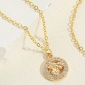Macro shot of gold pendant necklace with floral relief and circular crystal pavé setting - Flower Necklace (XL3413-2)