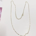 Detailed close-up of golden bar link necklace with lobster clasp and extension chain - Water Ripple Chain / 18k Gold
