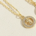Detailed macro view of gold-plated cupid necklace featuring a sparkling zircon circle - Little Girl Necklace (XL3128-3)