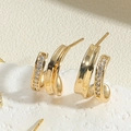 Macro shot of gold double J-hoops with S925 engraving and pavé set cubic zirconia - Double Layer J Zirconia Studs (ES2391-4)
