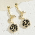 Close-up of gold rose earrings featuring black enamel petals and sparkling white zircons - Rose Enamel Earrings (ES2391-1)