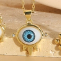 Macro detail of gold evil eye pendant necklace with zircon accents and spikes - Lower Eyelash Spiked Decor Style