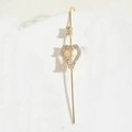 Close-up of golden heart-shaped ear hook with pave-set zircon crystals and long bar - Heart Ear Hook