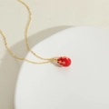 Elegant gold O-chain necklace featuring a red egg-shaped pendant with sparkling crystals - Red