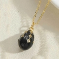 Vintage gold necklace with egg-shaped black enamel pendant and white zircon inlay - Black