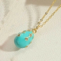 Elegant gold egg pendant necklace with turquoise enamel finish and sparkling crystals - Blue
