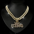 Close-up of hip hop gold Cuban link chain with a sparkling diamond encrusted KING crown pendant - Pendant And Chain / Gold
