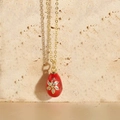 Vintage style gold chain necklace featuring a red Faberge egg pendant with floral zircon - Red