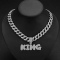 Macro shot of silver iced out KING letter pendant on a Cuban chain with clear crystals - Silver Pendant with Cuban Chain