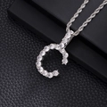 Macro shot of silver letter G pendant with cubic zirconia on a thick rope chain - C-Silver