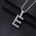 Close-up of iced out initial E pendant with cubic zirconia stones on rope chain. - E-Silver