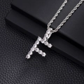 Macro shot of silver hip hop pendant letter F with cubic zirconia and rope chain - F-Silver