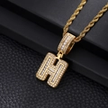 Macro detail of gold letter H pendant with iced out cubic zirconia and rope chain - Letter H / Gold