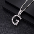 Close-up of hip hop letter G pendant with cubic zirconia and silver twist chain - G-Silver