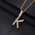 Macro shot of gold K-letter pendant with micro-paved zircons on a rope chain necklace - Letter K (Rope Chain) / Gold