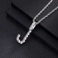 Macro detail of silver-tone letter J pendant with cubic zirconia on a rope chain - J-Silver