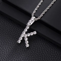 Macro detail of silver-tone letter K pendant with cubic zirconia and rope chain - K-Silver